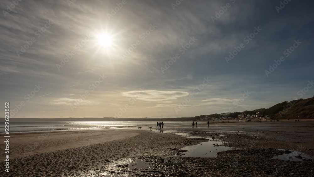 people walking on filey beach in autumn