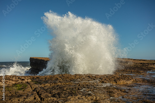 wave breaking on filey brigg