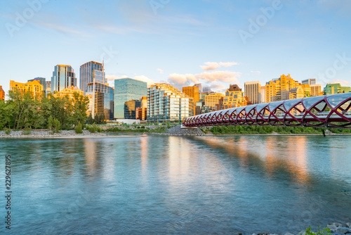 Skyline of the city Calgary, Alberta, Canada along the Bow River with Peace Bridge photo