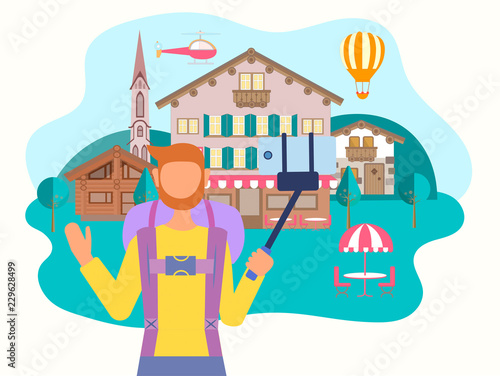 A tourist takes a selfie on a mobile phone against the backdrop of an alpine village.