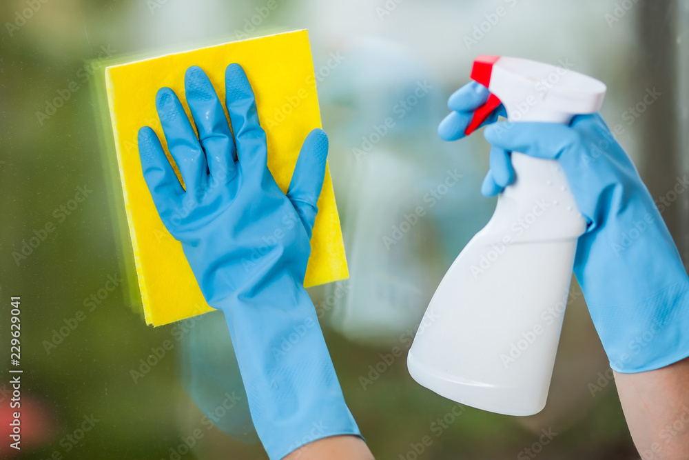 Hand in glove washes a window Hand in glove washes a window