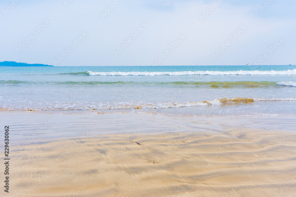 sandy beach with blue waves Sea background