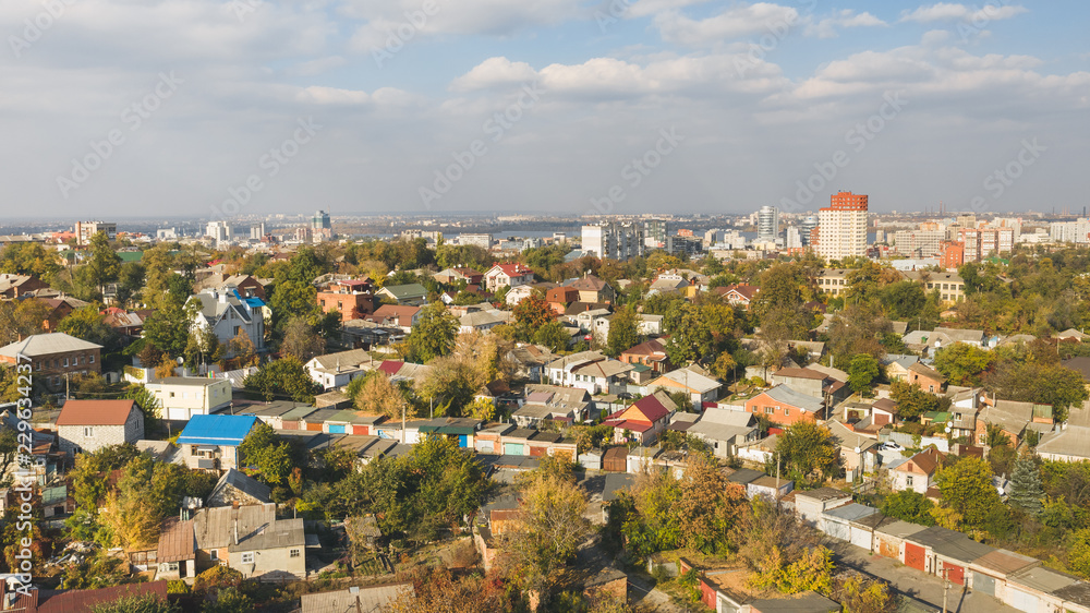 Panoramic view of autumn cityscape against skyline background.