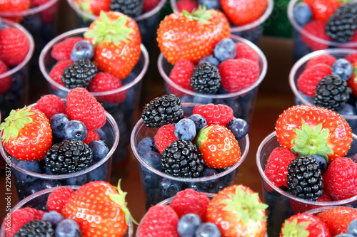 set of different berries in glasses
