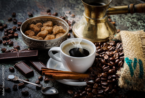 Black coffee in a cup on old background