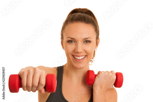 Beautiful young active fit woman workout with dumbbells isolated over white background - fitness
