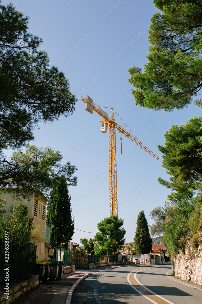 High iron construction crane in the city center in the South of France