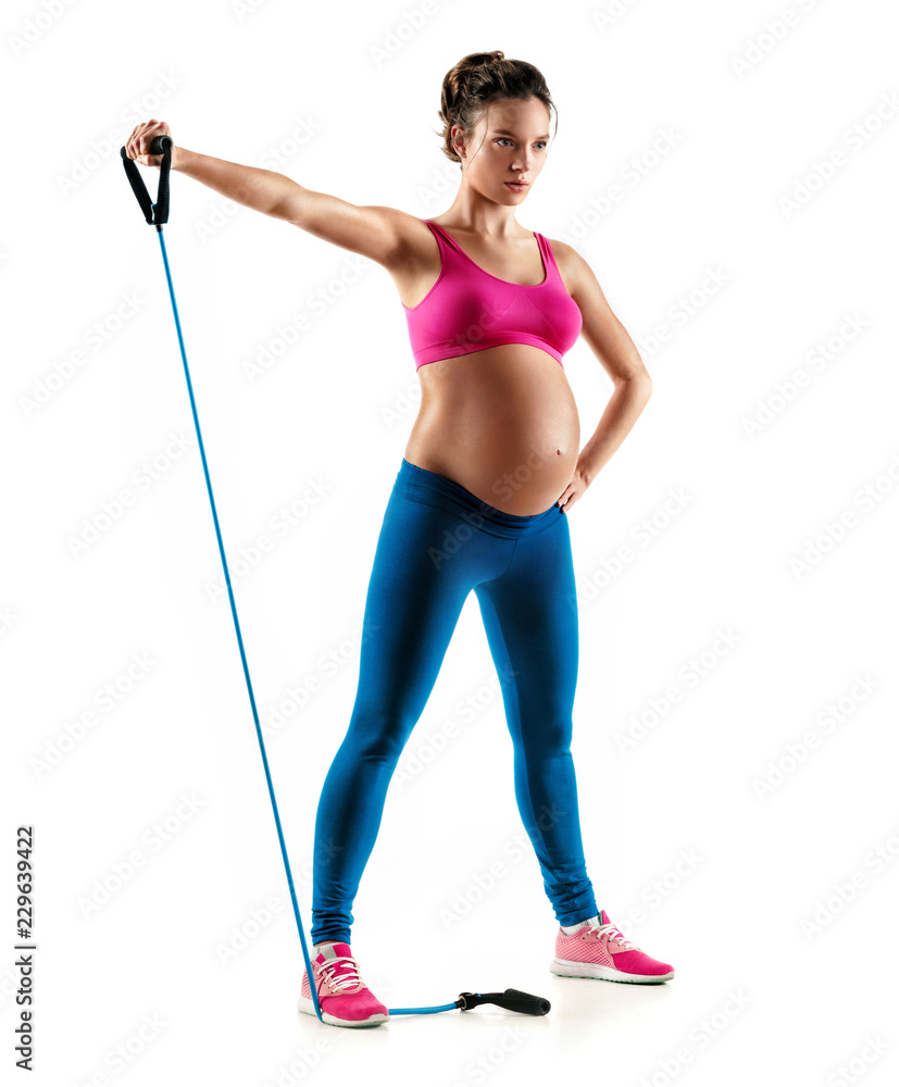 Sporty pregnant woman workout with expander isolated on white background. Concept of healthy life Sporty pregnant woman workout with expander isolated on white background. Concept of healthy life