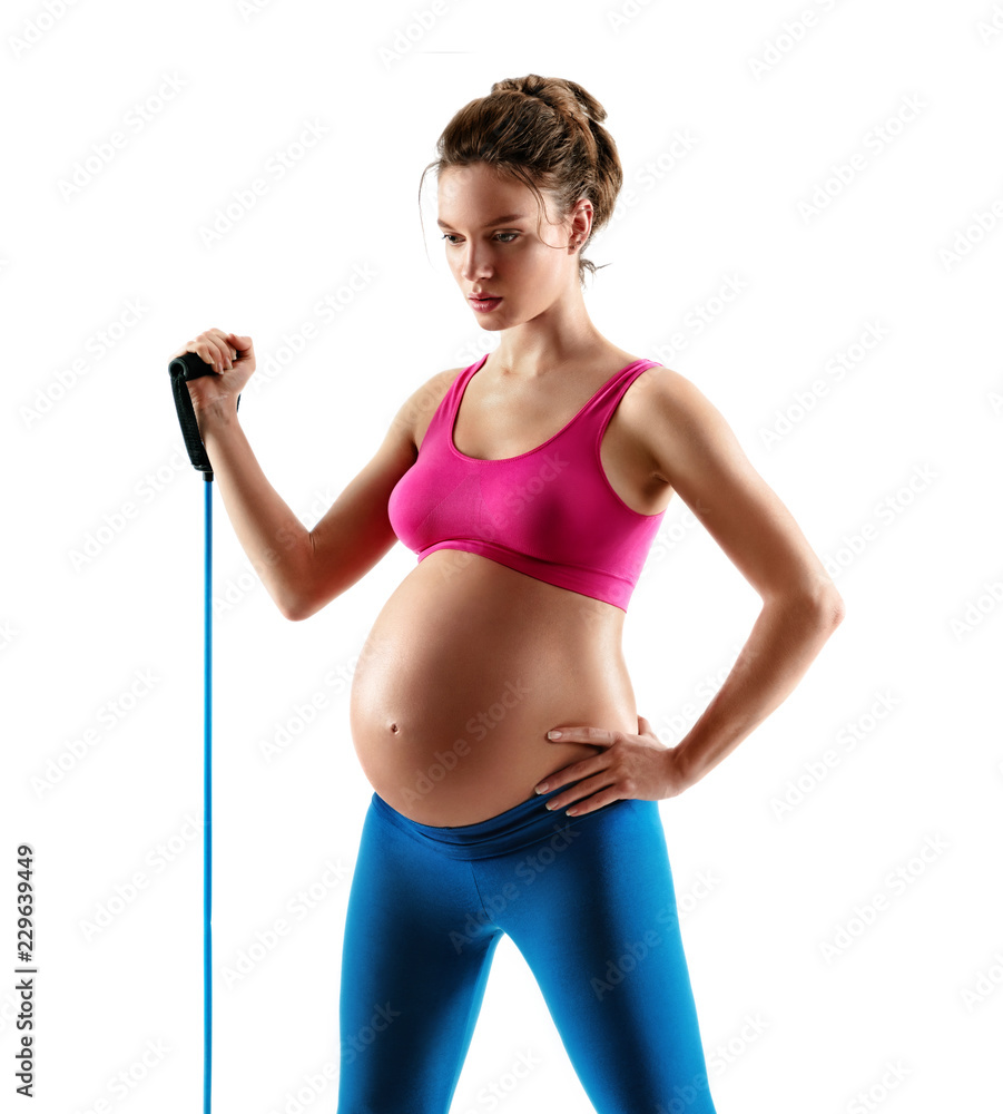 Sporty pregnant woman workout with expander isolated on white background. Concept of healthy life Sporty pregnant woman workout with expander isolated on white background. Concept of healthy life
