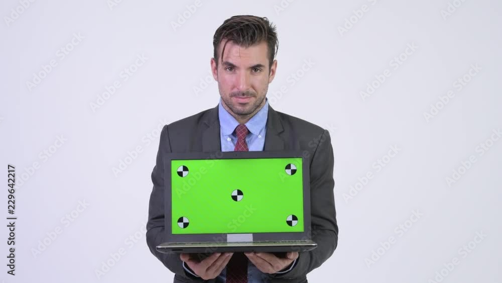 Young handsome Hispanic businessman showing and looking at laptop Young handsome Hispanic businessman showing and looking at laptop