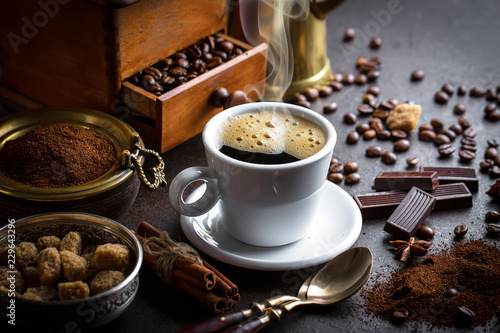 Black coffee in a cup on old background