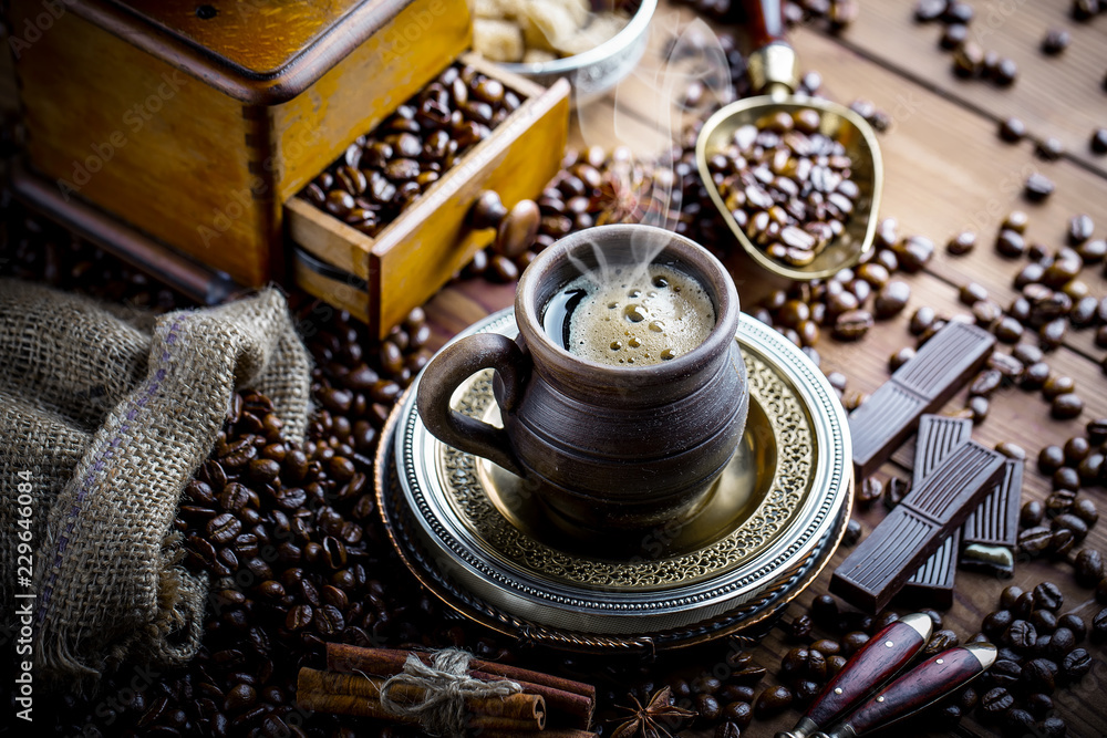 Black coffee in a cup on old background