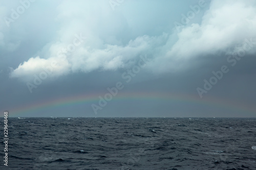 Rainbow over stormy sea
