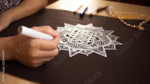 Girl looks at the mandala