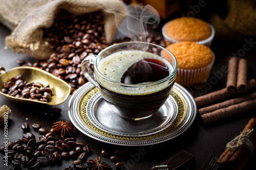 Black coffee in a cup on old background © Karnav