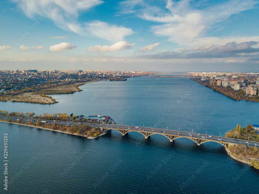 Aerial autumn Voronezh cityscape from drone flight height. View of the bridge over  Voronezh Water Reservoir