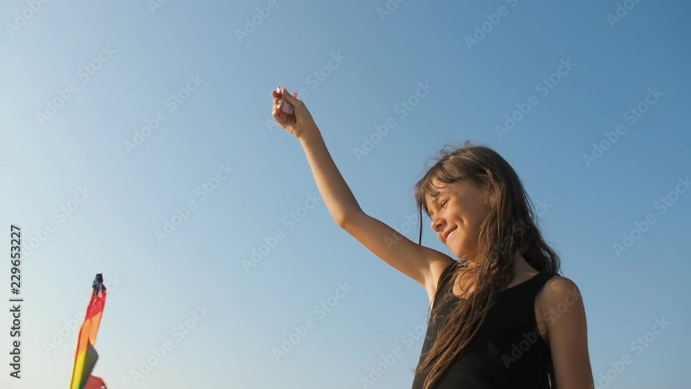 Happy child with a kite. Little girl playing with a kite against the sky. Happy child with a kite. Little girl playing with a kite against the sky.