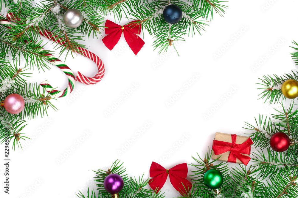 Christmas Frame of Fir tree branch with candy canes and snow isolated on white background with copy space for your text Christmas Frame of Fir tree branch with candy canes and snow isolated on white background with copy space for your text