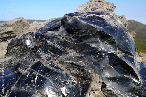 Large chunks of black obsidian glass exposed photo