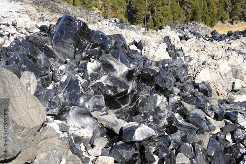 Large chunks of black obsidian glass exposed photo