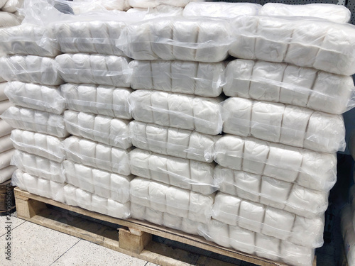 many sacks of sugar in warehouse on pallets