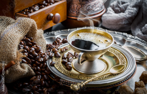 Black coffee in a cup on old background