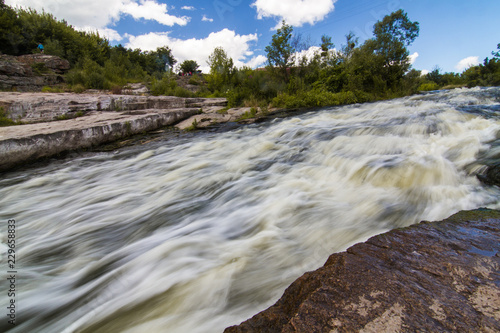 A small rapid at the  middle of Hirsky Tikych river with swallow water in Buky, Cherkasy region, Ukraine