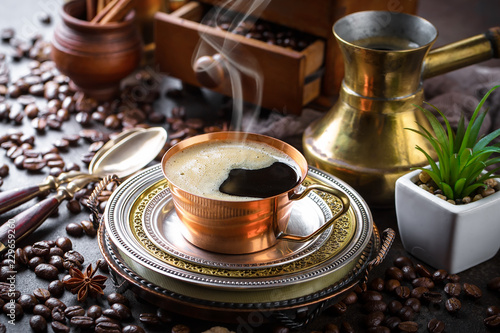 Black coffee in a cup on old background