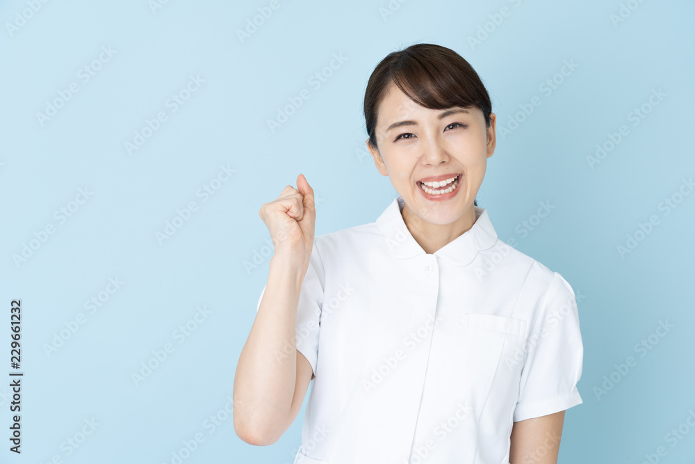 portrait of young asian nurse on blue background portrait of young asian nurse on blue background