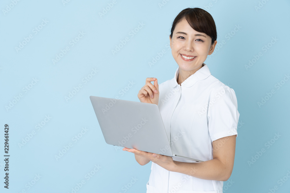 portrait of young asian nurse on blue background portrait of young asian nurse on blue background