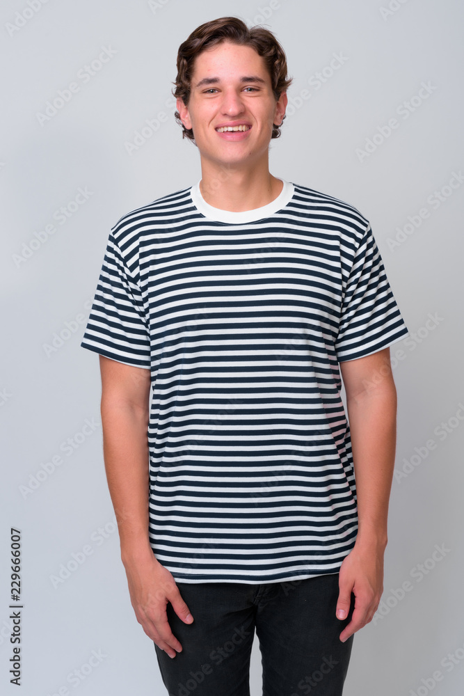 Young handsome man with wavy hair against white background Young handsome man with wavy hair against white background