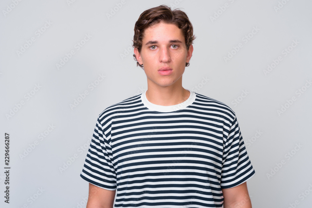© Ranta Images - Young handsome man with wavy hair against white background © Ranta Images - Young handsome man with wavy hair against white background
