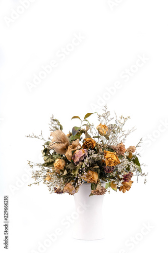 dried flowers in white vase
