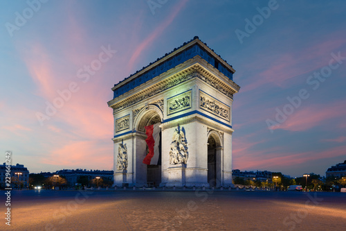 Arc de Triomphe Paris and Champs Elysees with a large France flag flying under the arch in Europe victory day at Paris, France.