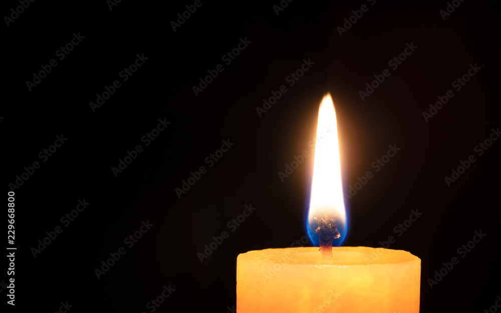 Flame and candle top in black background Flame and candle top in black background