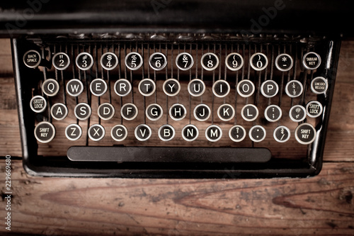 Vintage Metal Typewriter Keys on Old Wooden Trunk