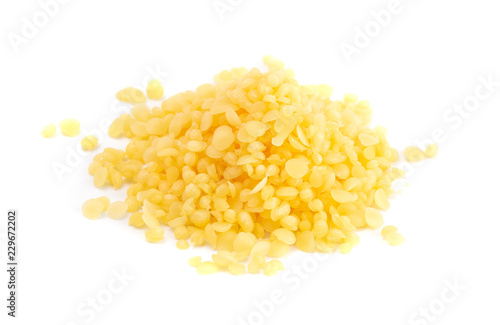 Pile of Natural Yellow Beeswax Pearls on a Wax Background