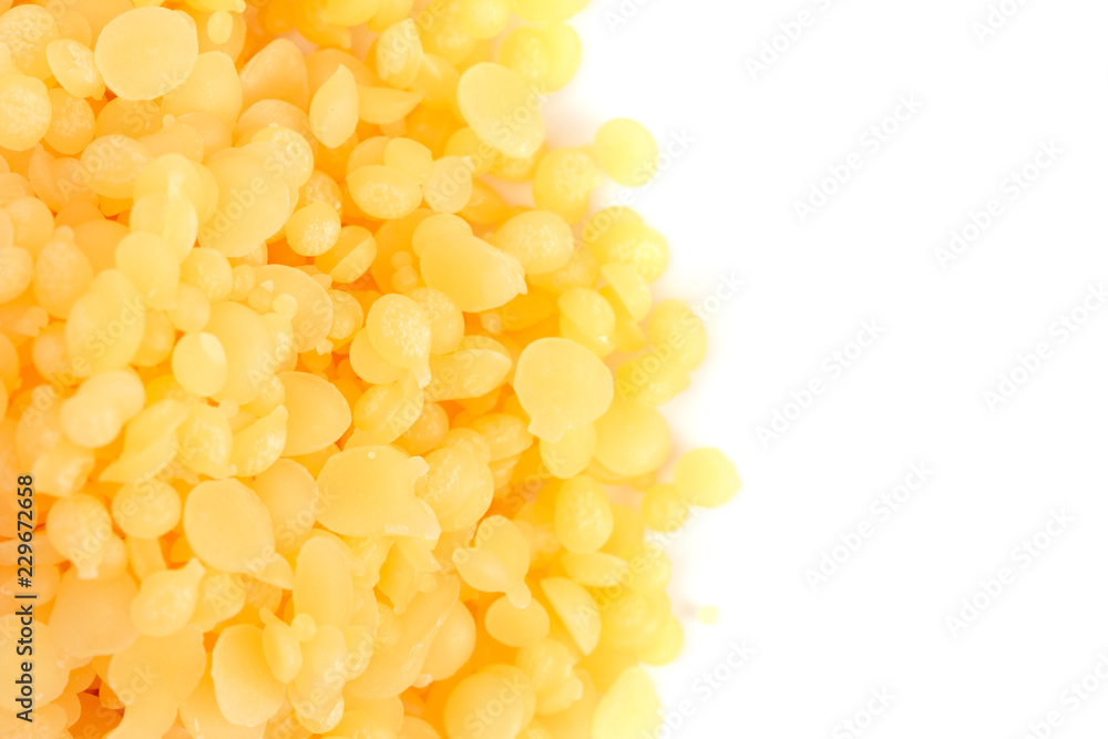 Pile of Natural Yellow Beeswax Pearls on a Wax Background Pile of Natural Yellow Beeswax Pearls on a Wax Background