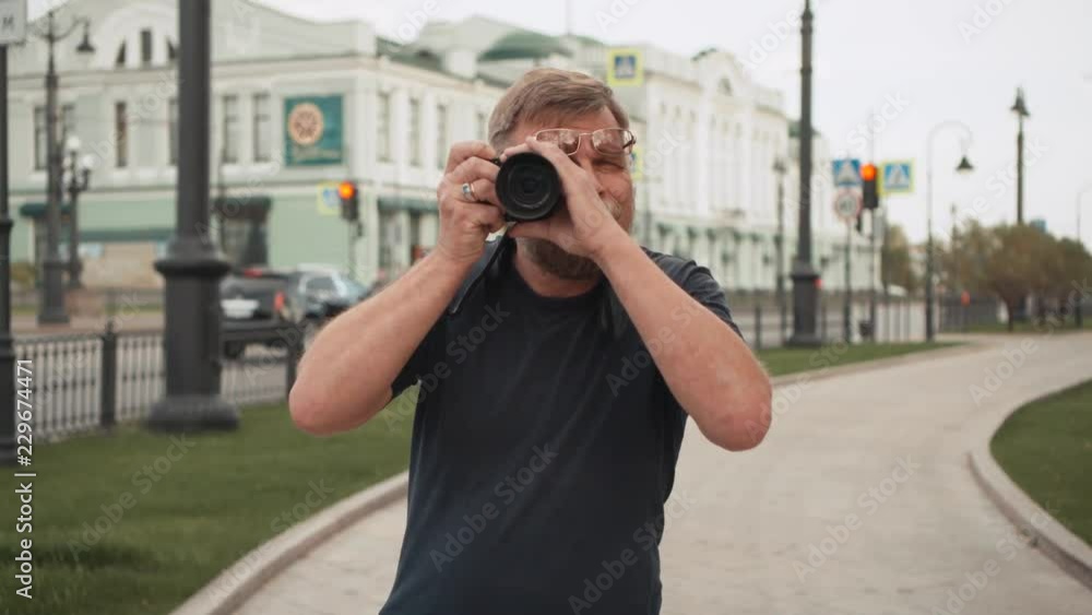 Tourist travel photographer photographing passers-by on the street. Tourist travel photographer photographing passers-by on the street.