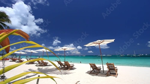 Tropical view with sun umbrellas and chairs photo