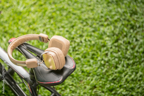 headphones and bike on grass coppy space.