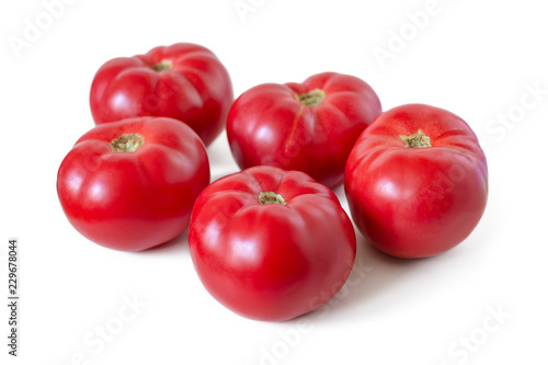 Five fresh, sweet, red tomatoes isolated on white background