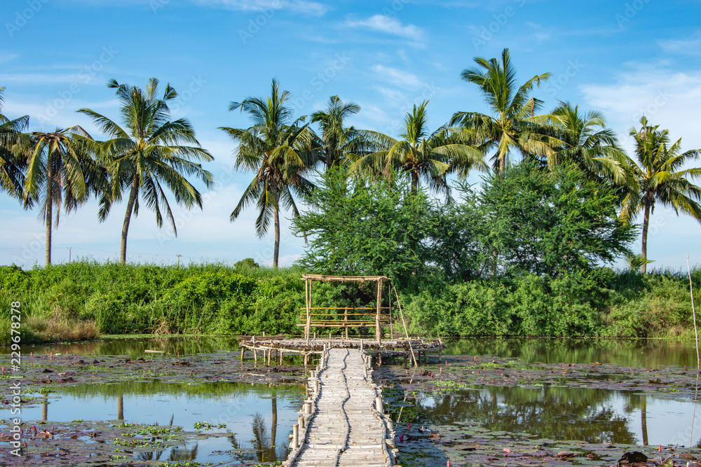 Obraz premium Bamboo walkway and Bamboo shack on the pond.