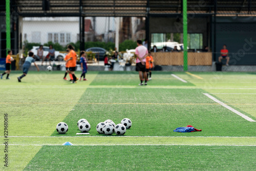 Training Ball in green soccer field © Kitti bowornphatnon