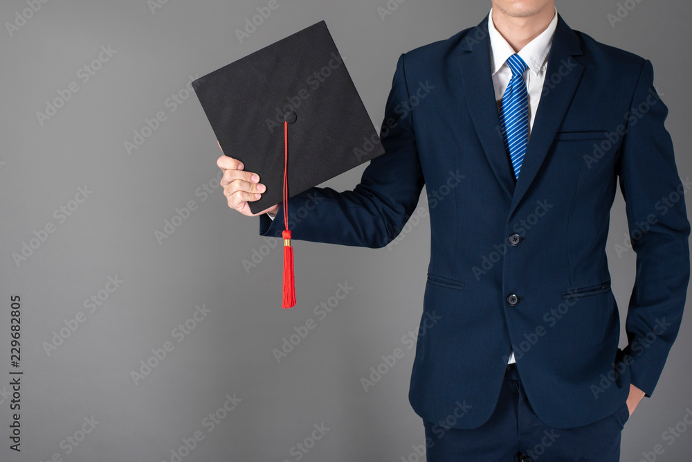 business man is holding graduation hat, business education concept business man is holding graduation hat, business education concept