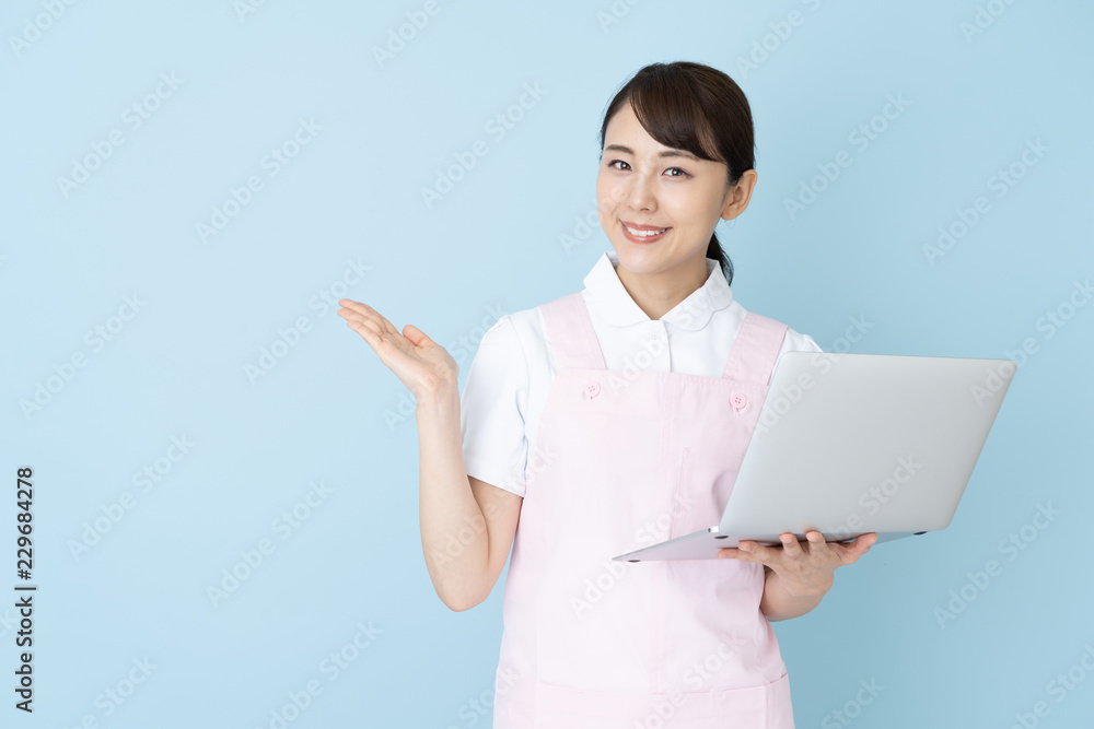 portrait of young asian nurse wearing apron on blue background portrait of young asian nurse wearing apron on blue background