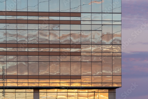 Business office building with colorful skies, reflecting the sunset colors of the glass windows