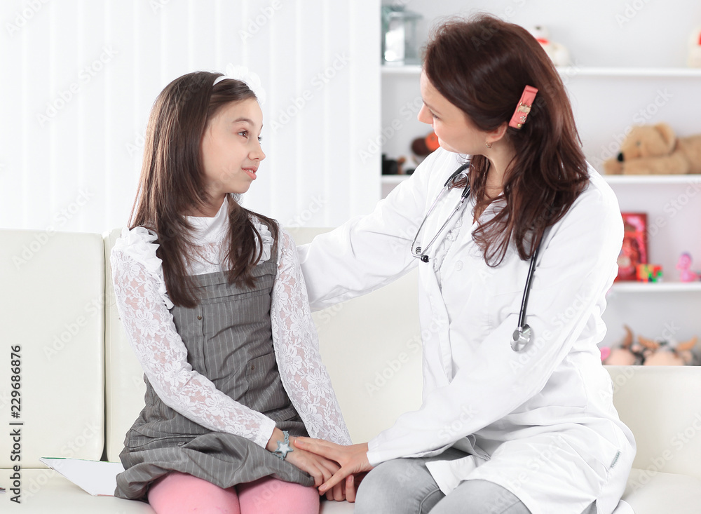 pediatrician positively explains the rules of treatment to the little girl pediatrician positively explains the rules of treatment to the little girl