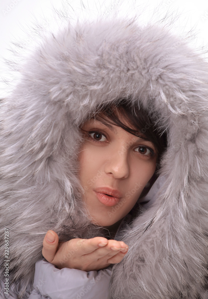beautiful young woman in winter jacket making a kiss. beautiful young woman in winter jacket making a kiss.