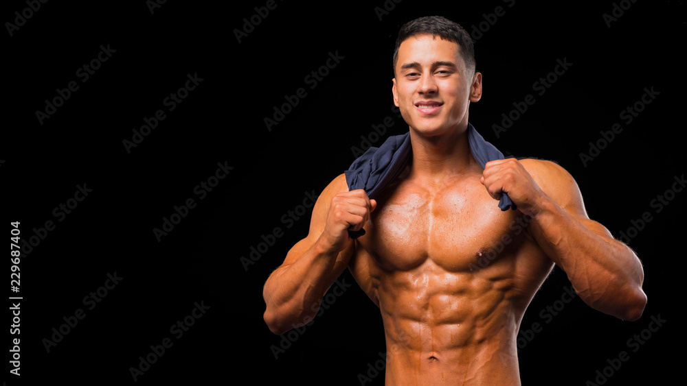 Fototapeta premium Muscular young man in studio on dark background shows the different movements and body parts.